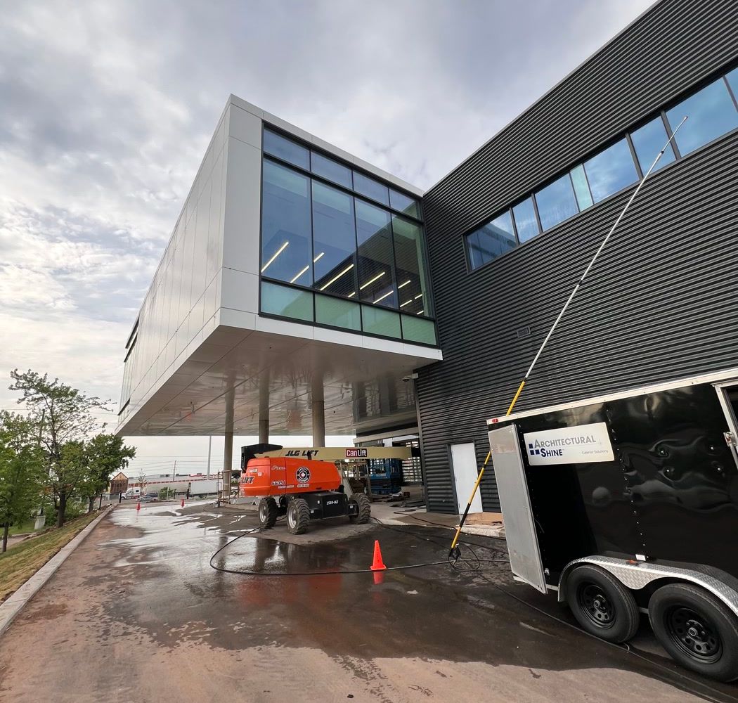 A dealership building's glass and composite panels after washing